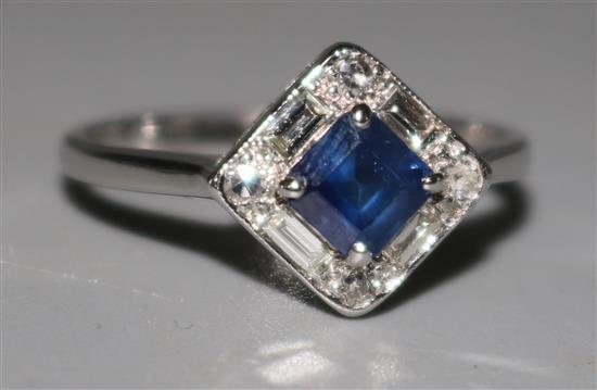 An 18ct white gold sapphire and diamond cluster ring, size O.